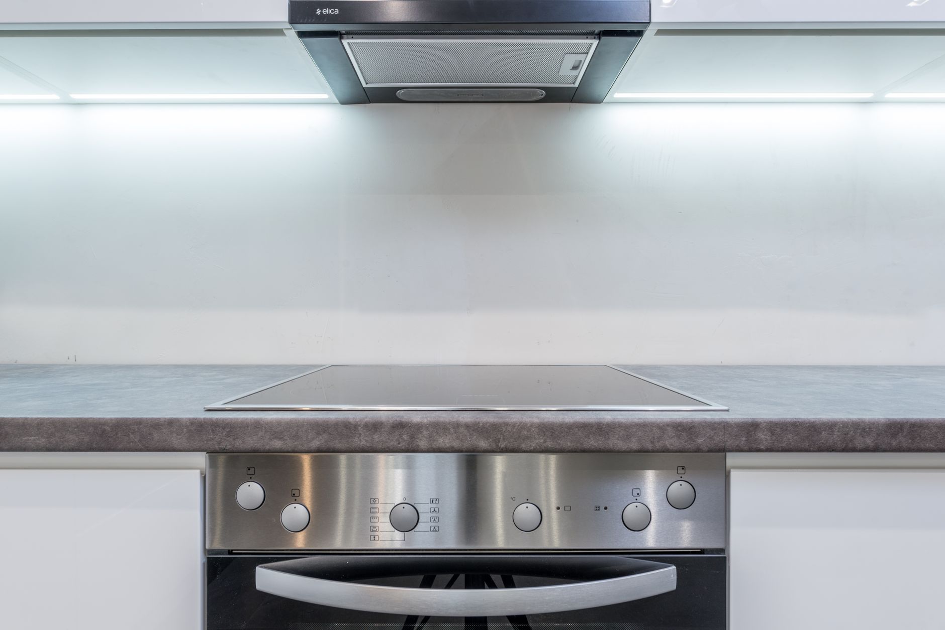 A modern kitchen counter featuring an energy-efficient induction cooktop in a bright home.