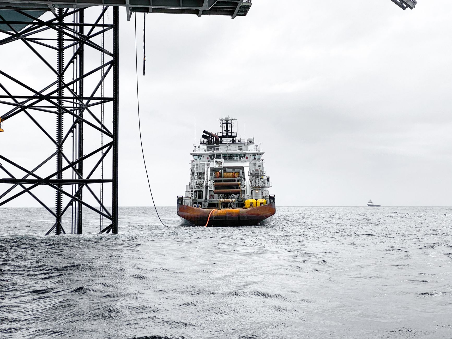 An offshore platform operating in the open sea under an overcast sky.